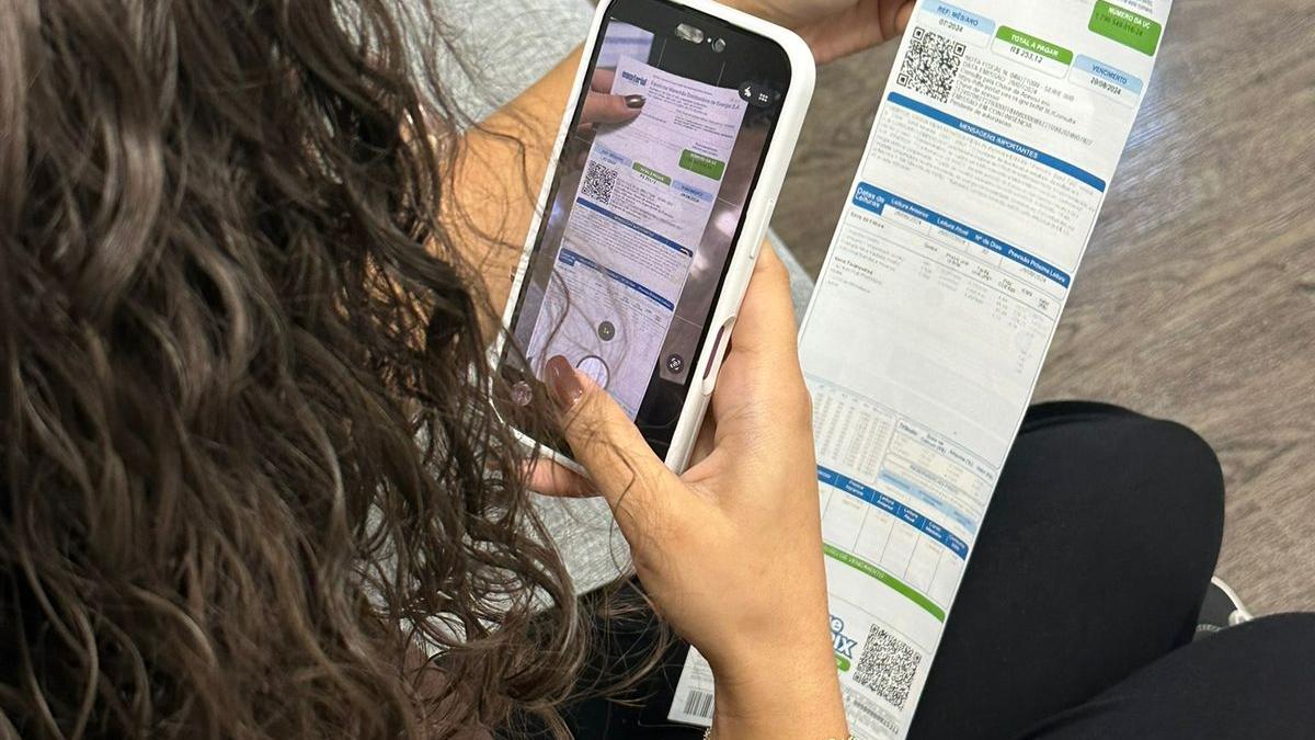 Consumidor consultando conta de energia no celular após atualização da Tarifa Social no Maranhão